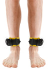 Model wearing yellow and black leather ankle restraints