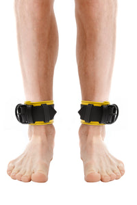 Model wearing yellow and black leather ankle restraints