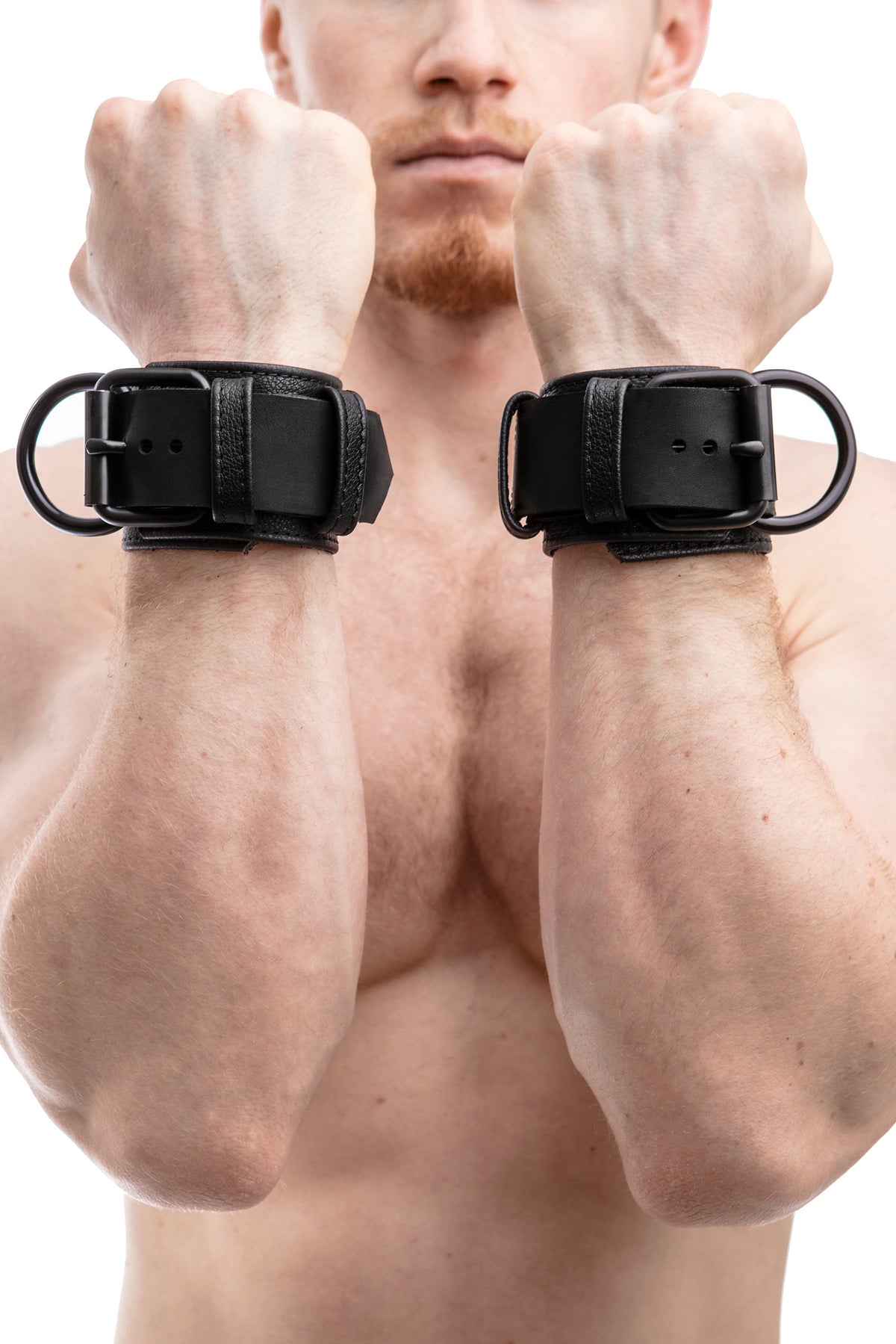 Model wearing black leather wrist restraints