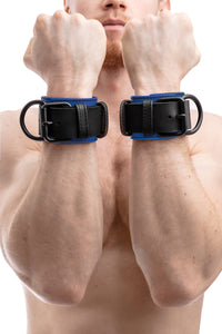 Model wearing blue and black leather wrist restraints