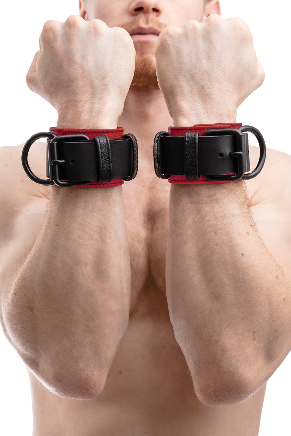 Model wearing red and black leather wrist restraints