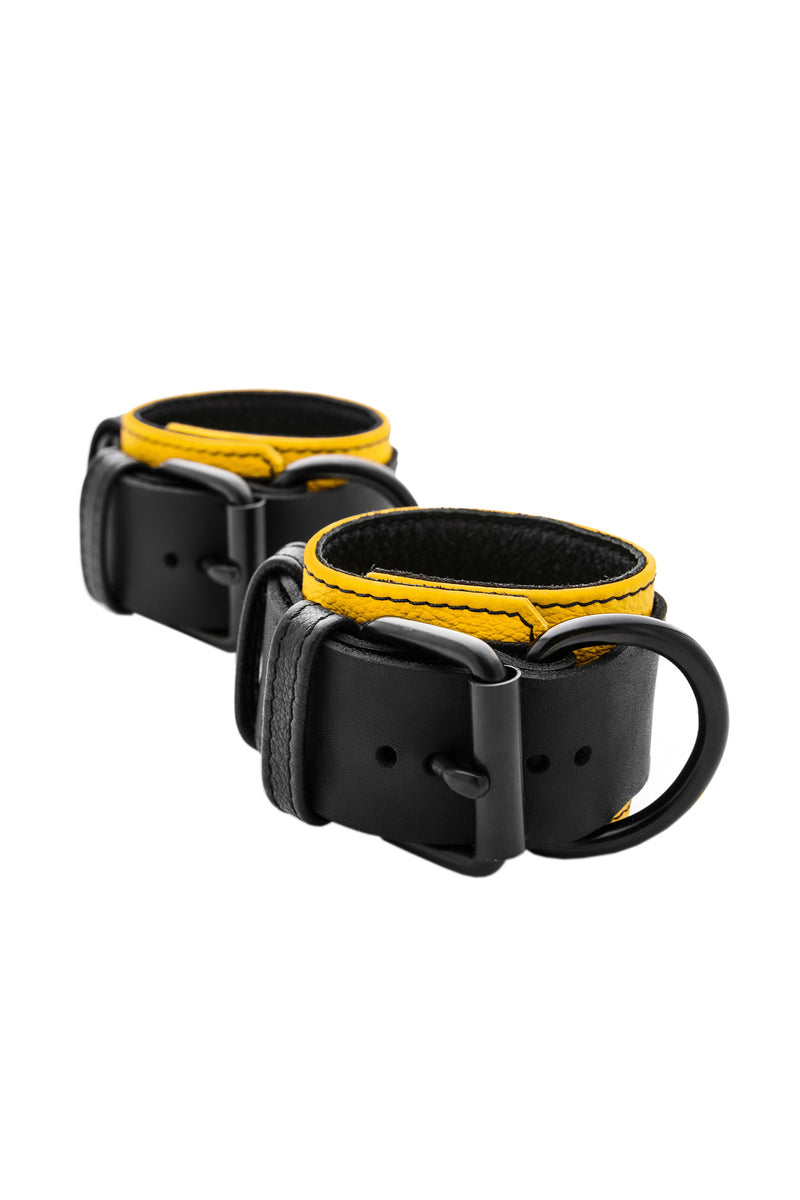 Yellow and black leather wrist restraints