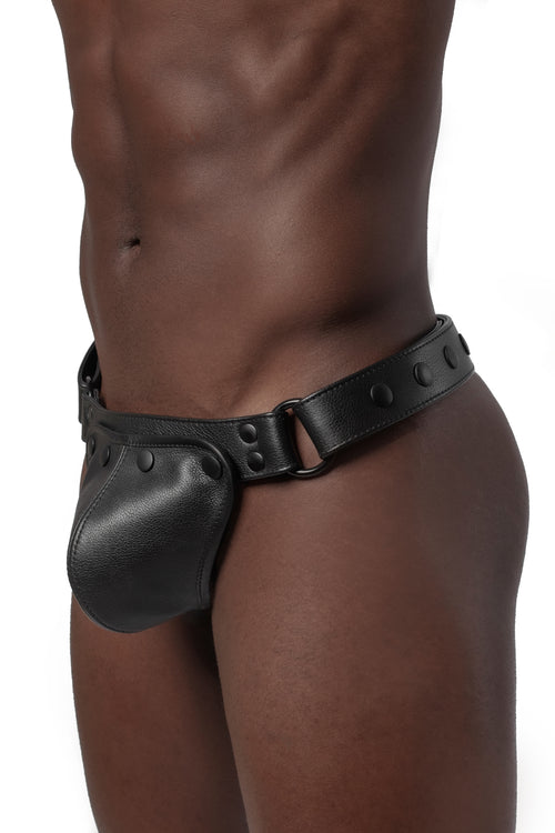 Model wearing black leather thong. Side view.