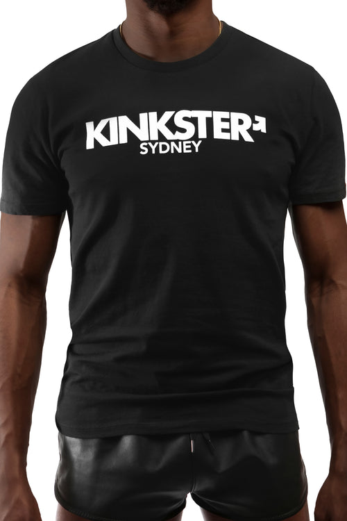 Model wearing black "KINKSTER SYDNEY" t-shirt. Front view.