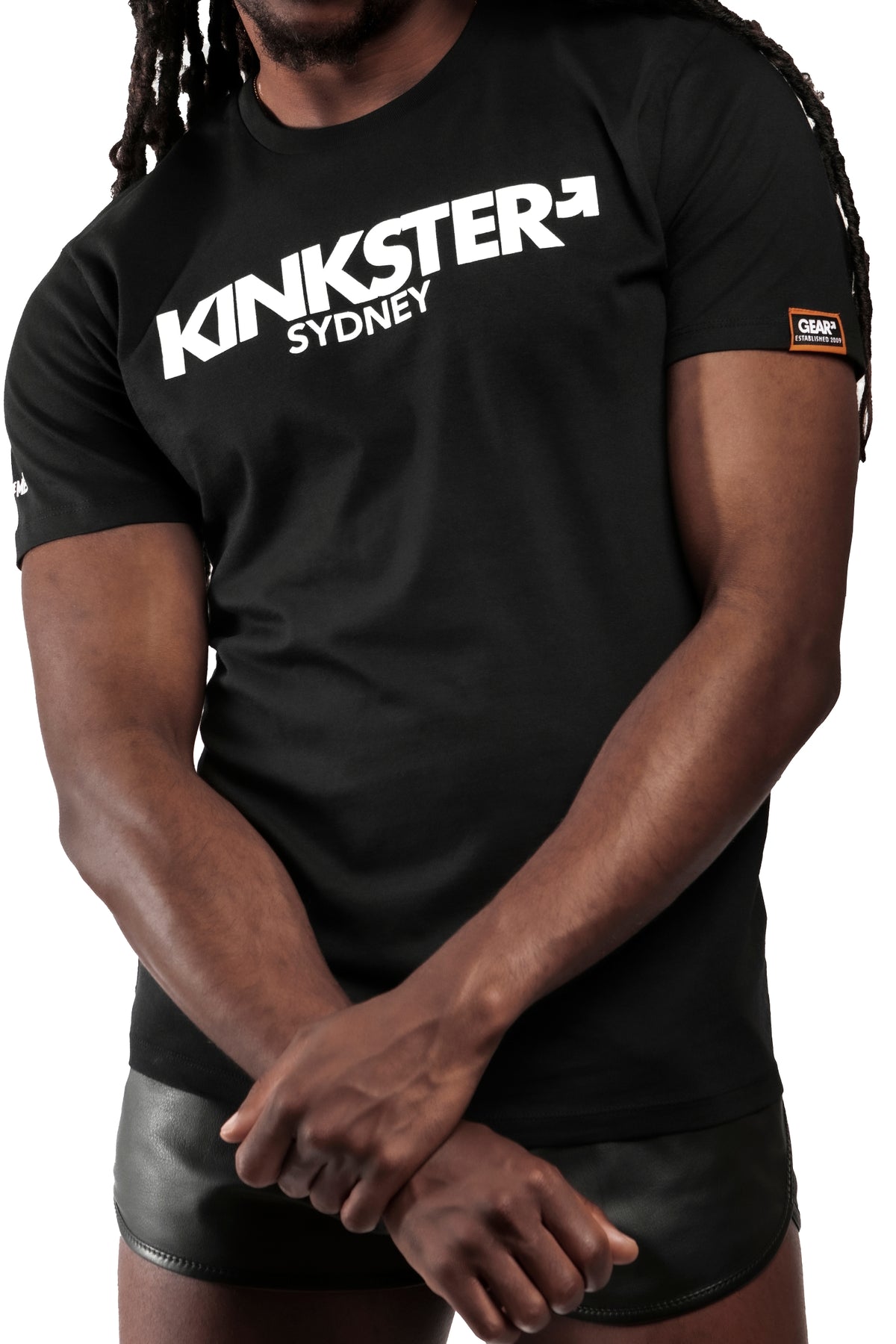 Model wearing black "KINKSTER SYDNEY" t-shirt. Front view.