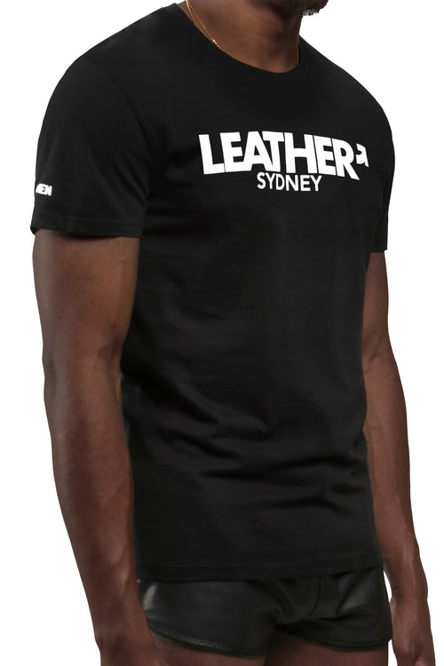 Model wearing black "LEATHER SYDNEY" t-shirt. Three quarter view.