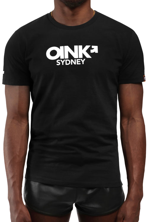 Model wearing black "OINK SYDNEY" t-shirt. Front view.