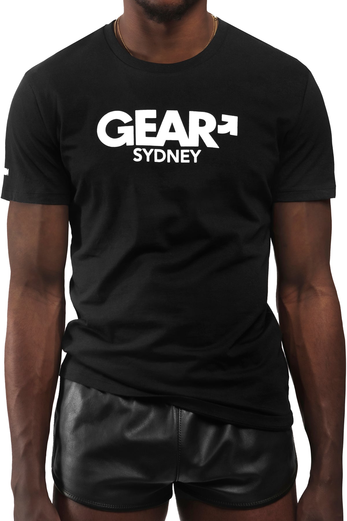 Model wearing black "GEAR SYDNEY" t-shirt. Front view.
