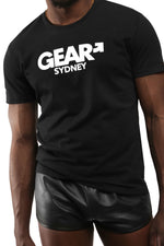 Model wearing black "GEAR SYDNEY" t-shirt. Front view.