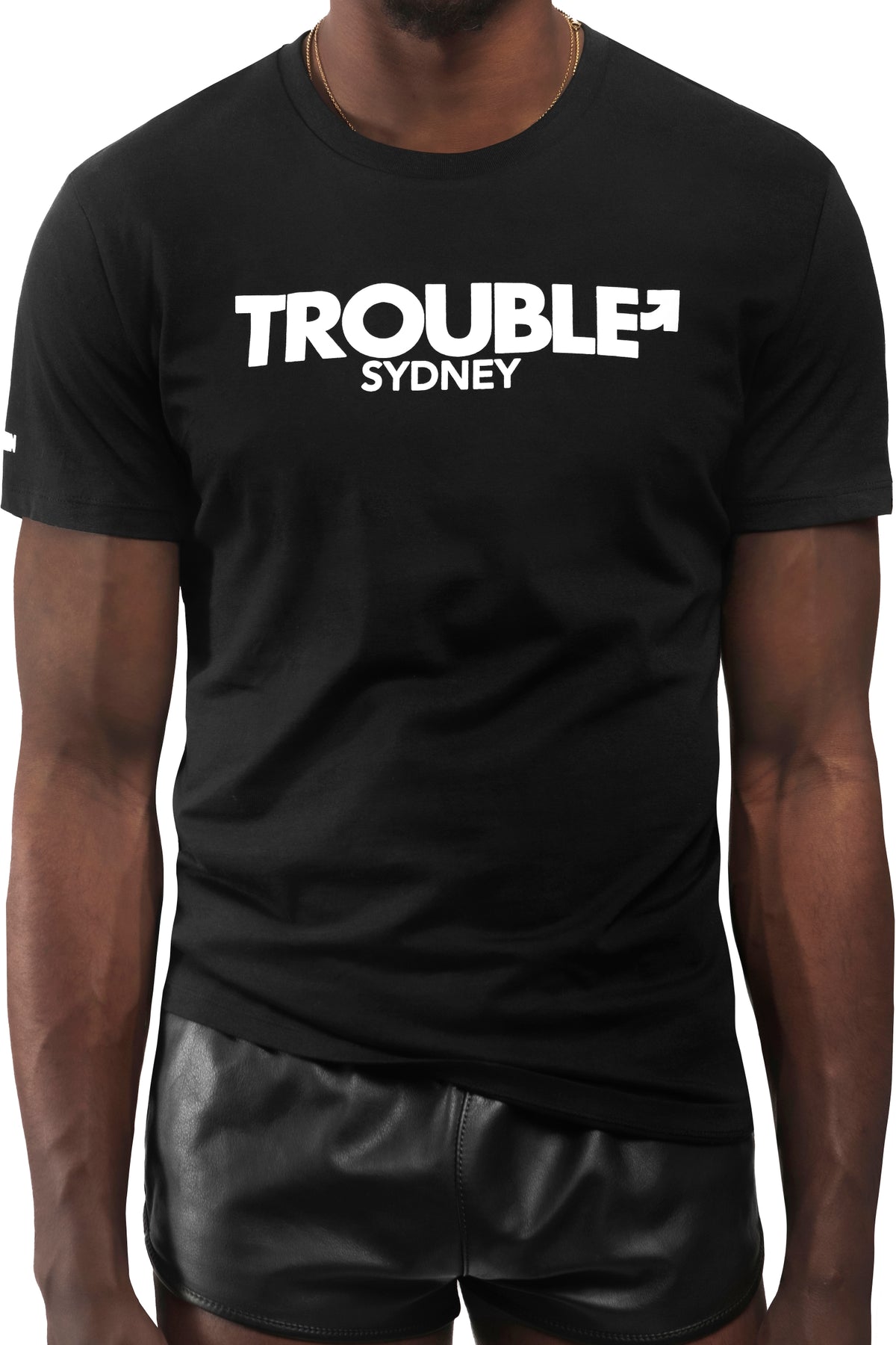Model wearing black "TROUBLE SYDNEY" t-shirt. Front view.