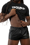 Model wearing black "TROUBLE SYDNEY" t-shirt. Front view.