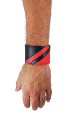 Model wearing a black leather wristband with red leather chevron detailing. Left Wrist.