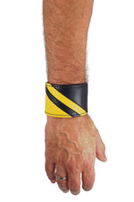 Model wearing a black leather wristband with yellow leather chevron detailing. Right Wrist.