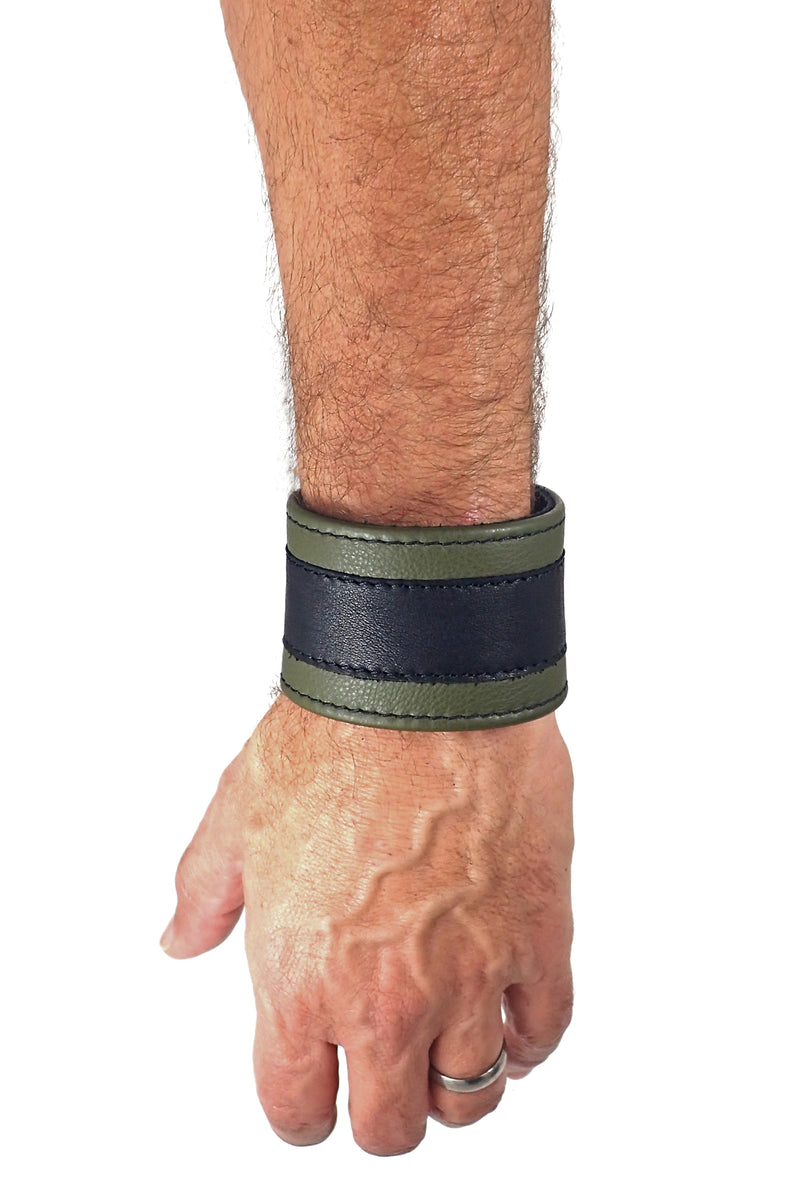 Model wearing a 2" wide leather wristband with army green leather racer stripe detailing