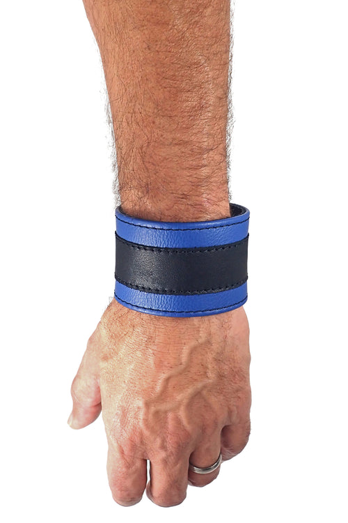 Model wearing a 2" wide leather wristband with blue leather racer stripe detailing