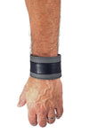 Model wearing a 2" wide leather wristband with grey leather racer stripe detailing