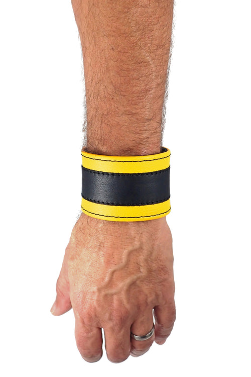 Model wearing a 2" wide leather wristband with yellow leather racer stripe detailing
