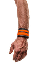 Model wearing a fluro orange leather stripe wristband