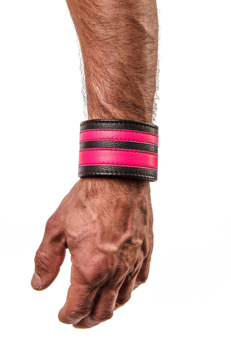 Model wearing a fluro pink leather stripe wristband