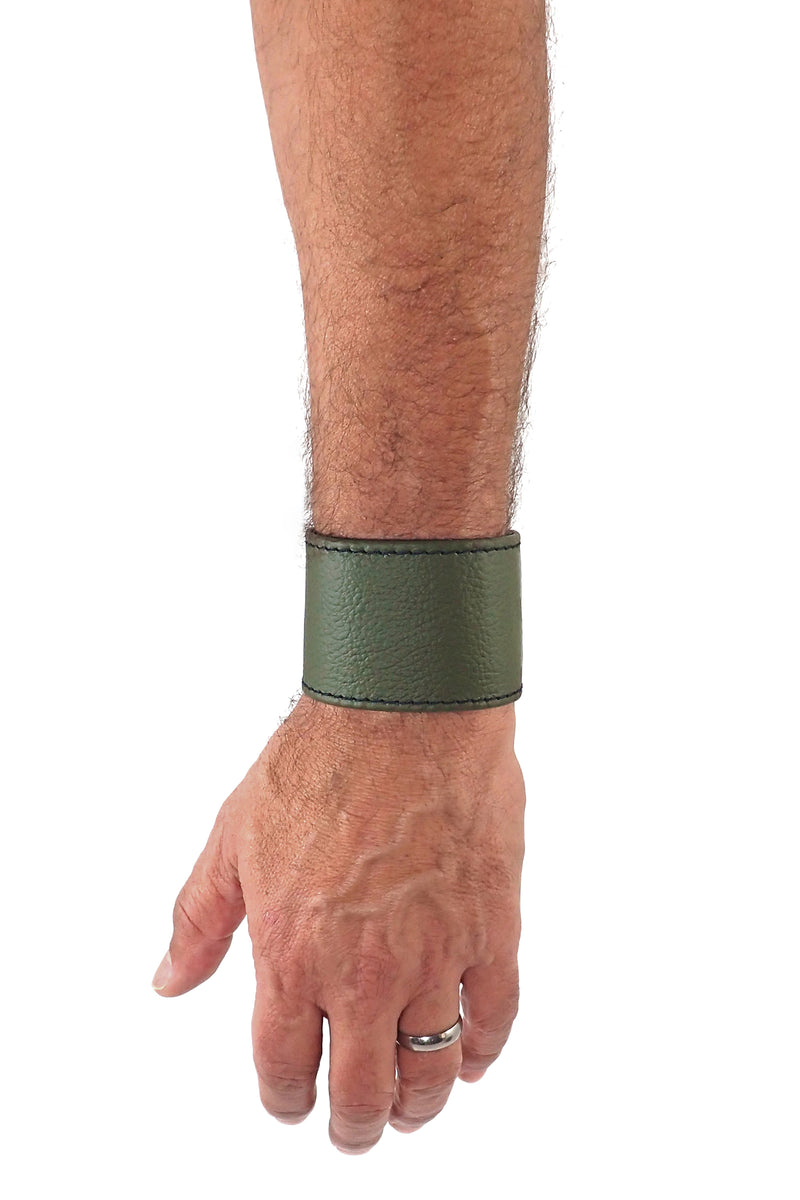 Model wearing an army green leather 2" wide leather wristband
