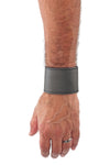 Model wearing a grey leather 2" wide leather wristband