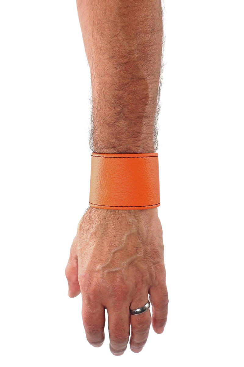 Model wearing an orange leather 2" wide leather wristband